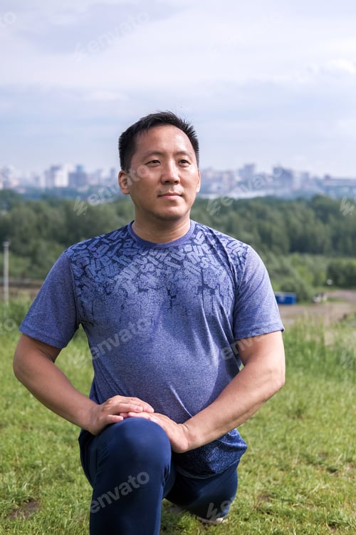Preview: Korean Man Stretches Against The Background Of The City. Healthy Lifestyle. Adult Man Practicing
