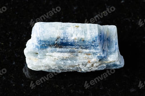 Preview: sample of rough kyanite rock on black granite