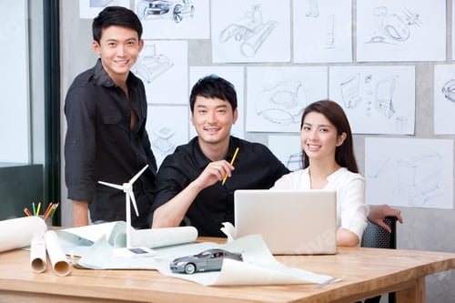 Preview: Designer team working before laptop in studio