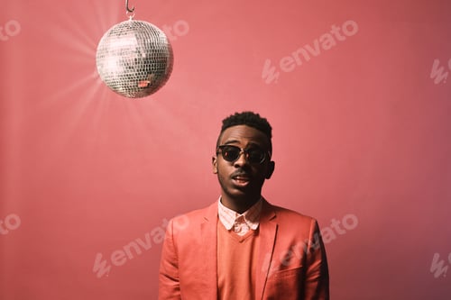 Preview: Studio Portrait of Young Black Man in Red Suit with Disco Ball