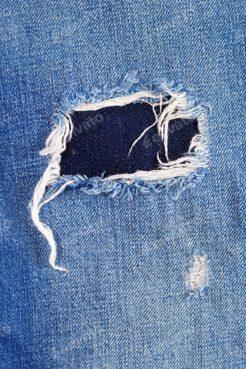 Preview: Blue jeans denim background texture. Torn jeans fabric material surface
