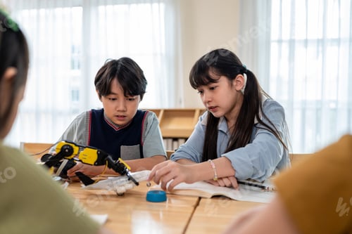 Preview: Group of students learning in a robotics class at elementary school.