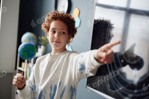 Preview: Caucasian Boy Pointing at Solar System Diagram While Holding Globe Model