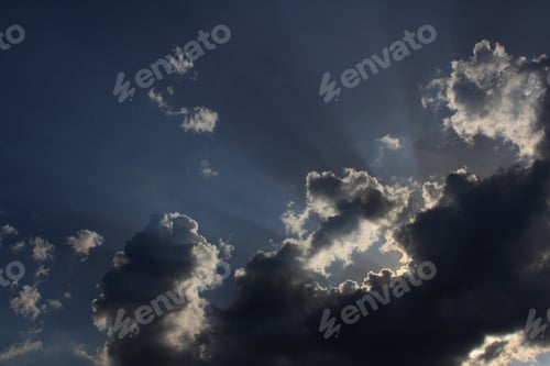 Preview: Dramatic Sky With Sun'S Rays Shining Upwards, From Behind Clouds.