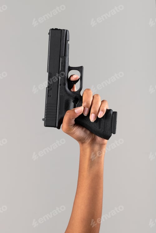 Preview: Black female hand with handgun