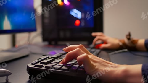 Preview: Close-up of gamer using RGB keyboard and mouse