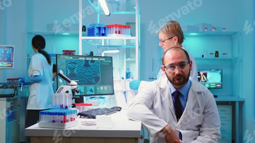 Preview: Portrait of experienced scientist man looking tired at camera