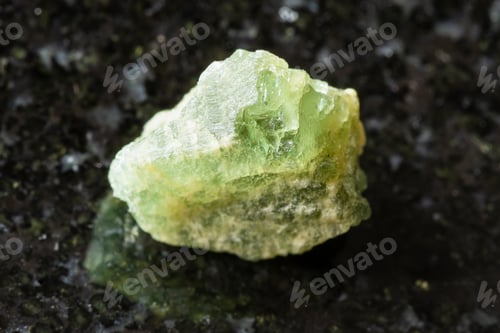 Preview: sample of rough yellow green beryl rock on black