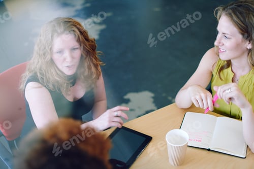 Preview: Unposed group of creative business people in an open concept off