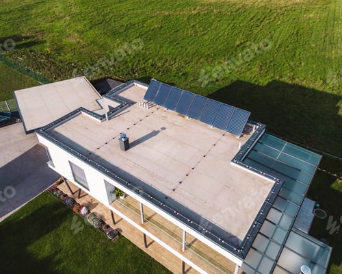 Preview: Modern family home, view from the air with solar panels on the roof top
