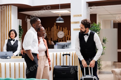 Preview: Hotel steward carrying bags at resort