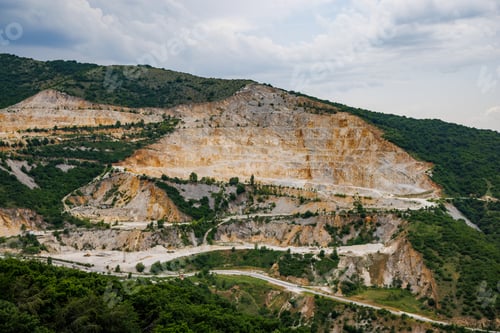 Preview: Natural quarry is located near road against backdrop of Rhodope Mountains and hills with forests