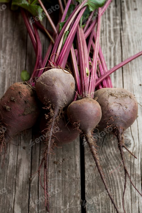 Preview: Organic red beet with green leaves on an old wooden background. Copy space