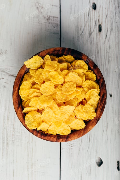 Preview: Breakfast cornflakes in a wooden bowl