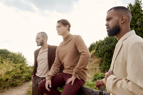 Preview: Stylish male models enjoy an autumn day in a serene natural setting during golden hour