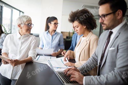 Preview: Group of young business people working and communicating at the office