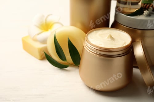 Preview: Set of hair cosmetic products and flowers on white wooden table, closeup