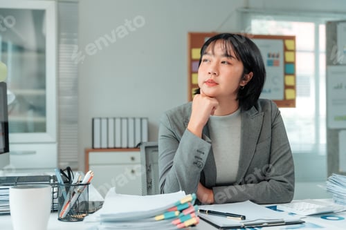 Preview: Businesswoman thinking and planning new project at workplace