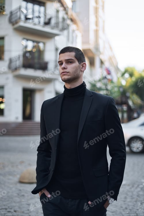 Preview: Confident young man walking on a European city street