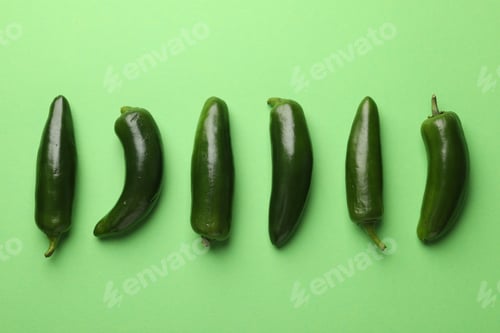 Preview: Ripe jalapeno peppers on light green background, flat lay