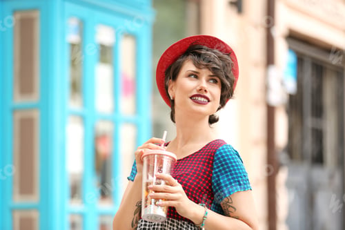 Preview: Young woman with cup of tasty lemonade outdoors