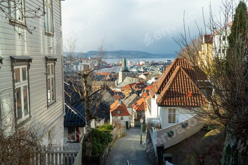 Preview: Narrow street in Bergen with Bergen Cathedral in the background. Vestland county, Norway.