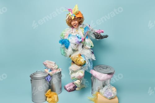 Preview: Nature pollution concept. Studio photo of young happy smiling African american lady in costume of