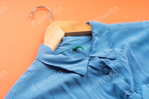 Preview: Light Blue Shirt on Hanger on Orange Background