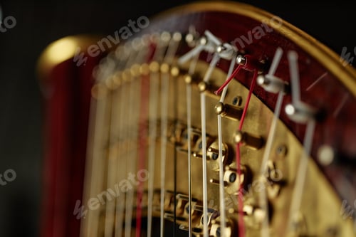 Preview: Tensing Strings on Tuning Pins and Levers of Antique Harp in Dim Indoor Light