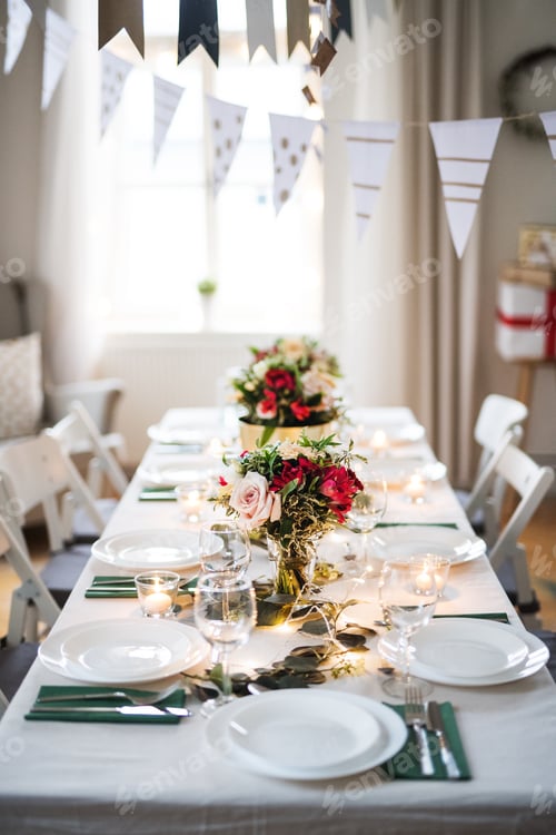 Preview: Table set for a meal indoors in a room on a party, a wedding or family celebration.