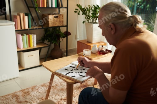 Preview: Senior Man Solving Crossword