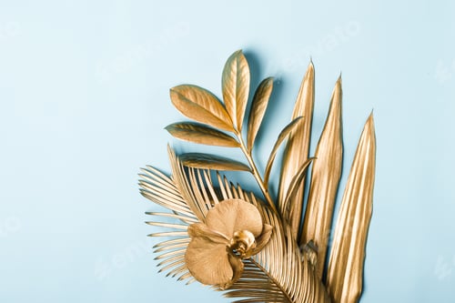 Preview: Tropical palm leaves and flowers in golden colors on pastel background. Natural Creative layout