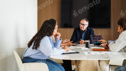 Preview: Multigenerational business people sharing ideas inside company office
