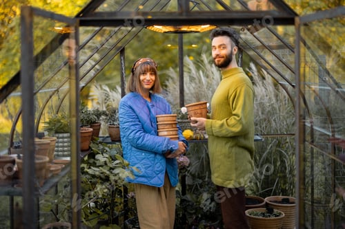 Preview: Young couple in greenhouse at garden