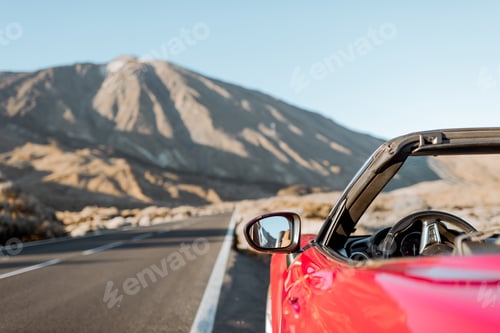 Preview: Convertible car on the roadside of the desert valley