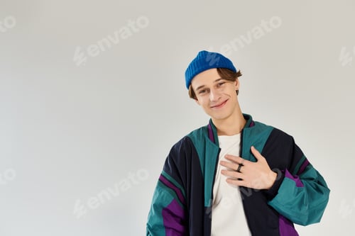 Preview: Young man in stylish bomber jacket expresses confidence in a studio setting