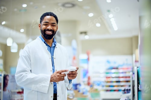 Preview: Confident Pharmacist Smiling While Working in Bright Modern Pharmacy