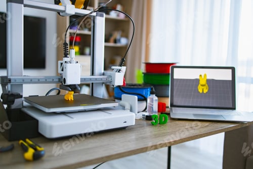 Preview: 3D Printer Making Object With Laptop Showing Design