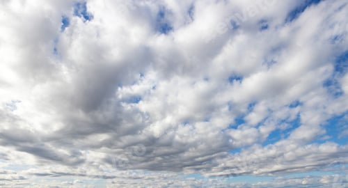 Preview: White clouds rolling in under blue sky