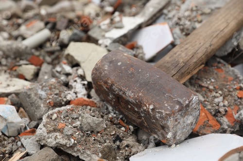 Preview: Sledgehammer on pile of broken bricks, closeup