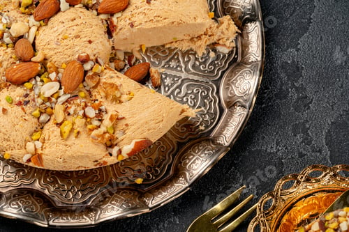 Preview: Close up photo of halva dessert on silver plate