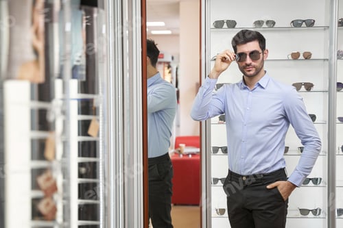 Preview: Caucasian man staring ahead while wearing sunglasses