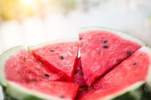 Preview: Juicy bright red pieces of sliced watermelon on a black table background.