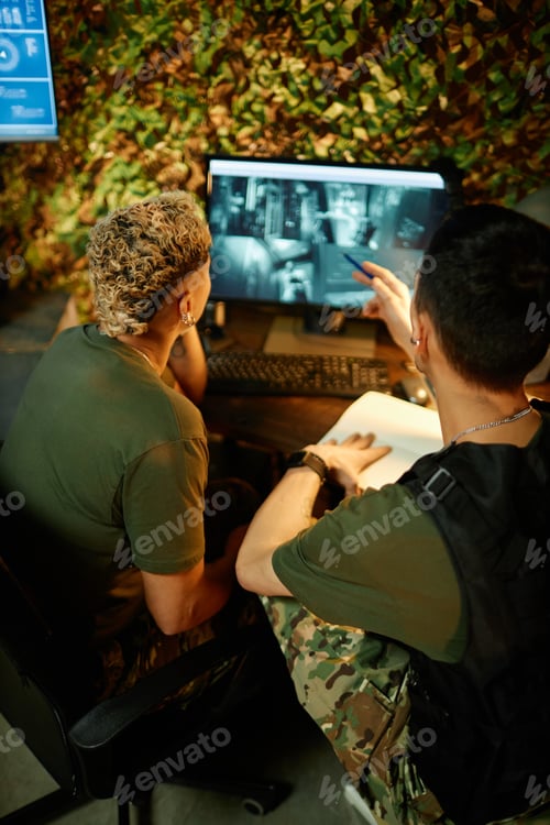 Preview: Young confident male officer explaining something to female colleague