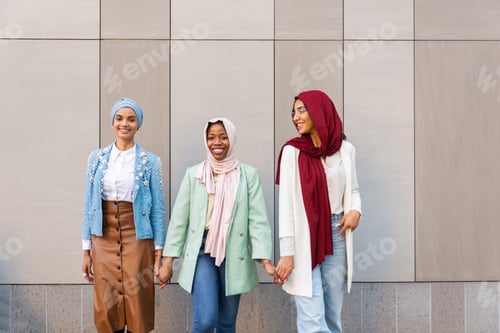 Preview: Beautiful muslim girl wearing hijab bonding outdoors