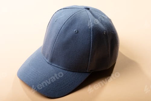 Preview: Composition of traditional peaked grey baseball cap on pale brown background