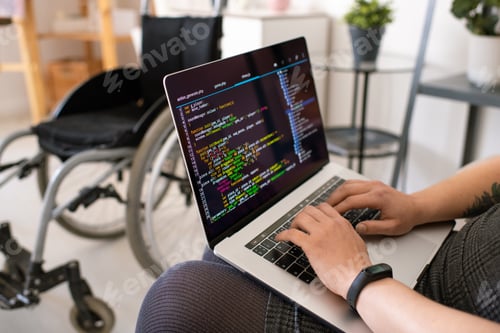 Preview: Hands of young contemporary disable female programmer touching laptop keys