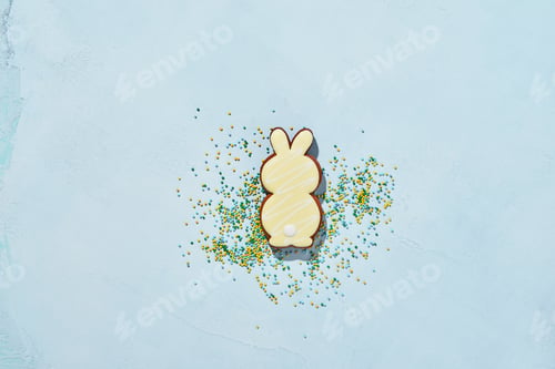 Preview: Easter baking background. Easter rabbit gingerbread and scattered confectionery topping dressing on