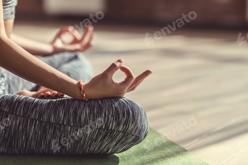 Preview: Young woman in lotus pose close-up