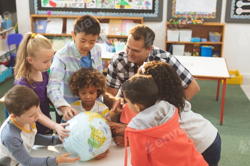 Preview: Schoolteacher interacting with his pupils over a earth globe putting on a table in classroom
